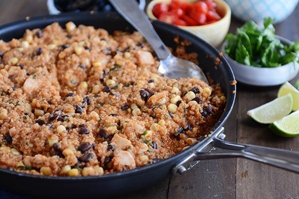 A skillet full of a quinoa chicken enchilada black bean meal.