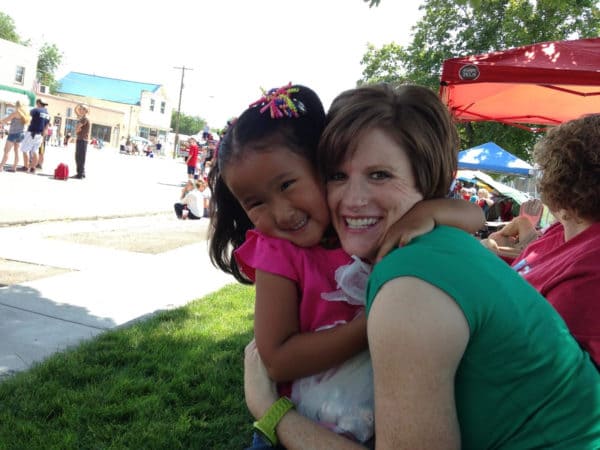 A lady hugging a little girl.