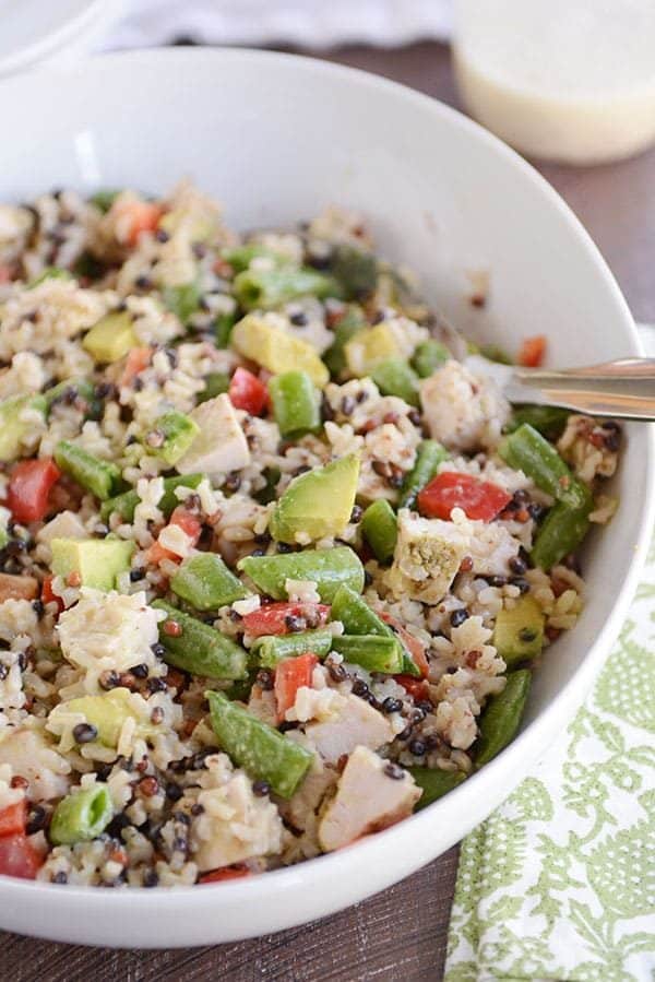 A large oval white bowl of santa rosa chicken and wild rice salad. 