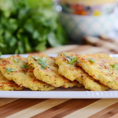 These delicious little spaghetti squash fritters are going to rock your world! Baked, not fried, they are loaded with Parmesan flavor and are so easy to make!