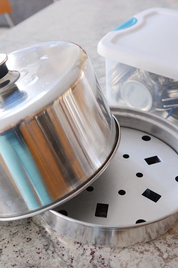 A steam canner with the lid partway off. 