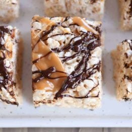 Top down view of Toasted Coconut Caramel Rice Krispie Treats on parchment paper.