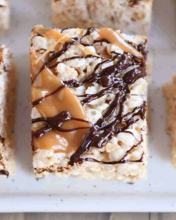Top down view of Toasted Coconut Caramel Rice Krispie Treats on parchment paper.