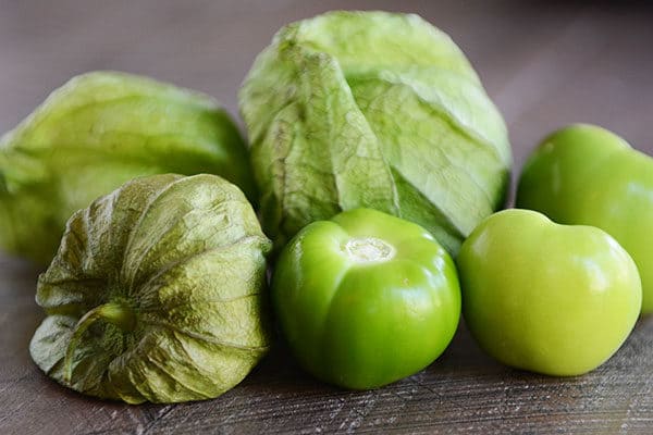 Green tomatillos on a counter.