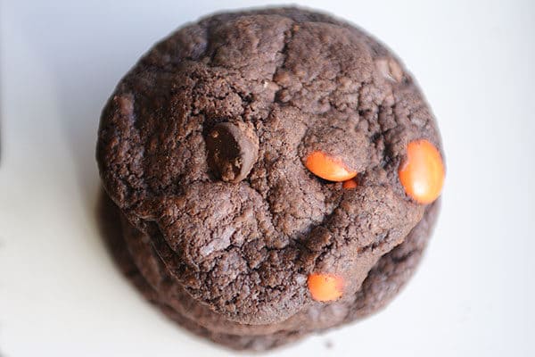 Top view of a stack of chocolate M&M cookies.
