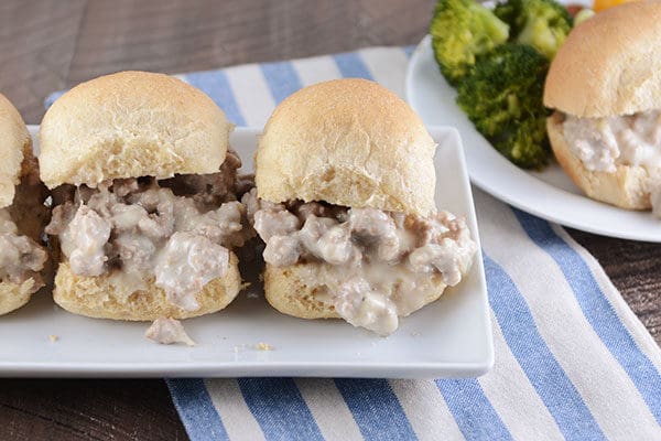 Cheesy turkey sloppy joe's on homemade rolls, on a white rectangular platter. 