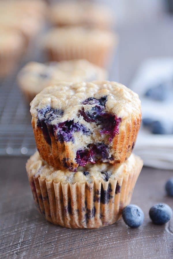 Two blueberry muffins stacked on top of each other.