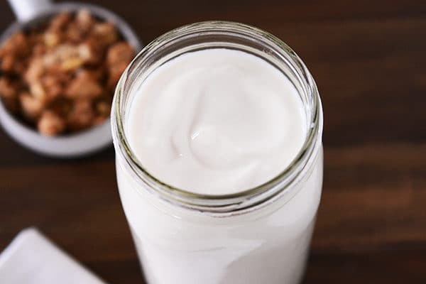 A top view of a mason jar full of homemade yogurt.